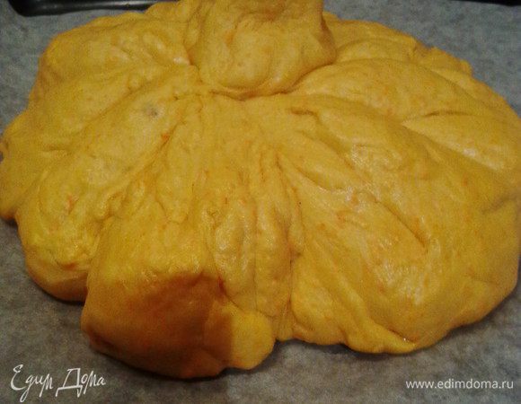 Из теста сделать колобок (семечки внутри). Затем выложить его на противень застеленный пергаментом и перевязав плотными нитками, сделать 8 секторов (нитки предварительно смочить водой). Обвязывать не очень плотно, т.к. тесто ещё подрастет. В центре тыковки хвостик, его можно сделать из теста, а можно водрузить настоящий, средств с другой традиционной тыквы.