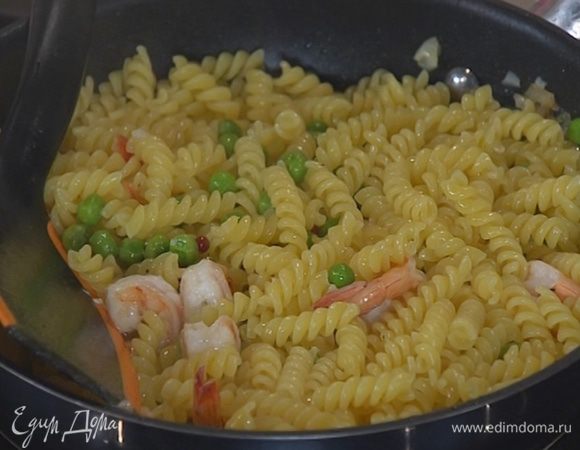 Выложить к креветкам с горошком готовые макароны, влить 2 ст. ложки воды, в которой они варились, перемешать.