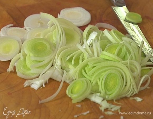 Светлую часть лука-порея нарезать тонкими кольцами.