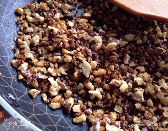 Орехи измельчить ножом. Затем прожарить минуту-две на раскаленной сковороде, добавить 2 чайные ложки сахара и еще прожарить 1–2 минуты.