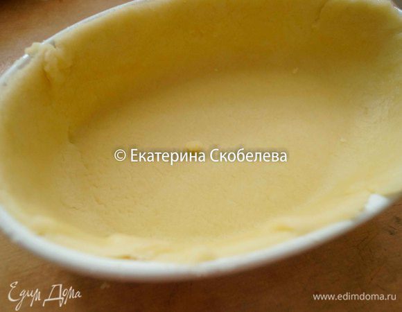 Форму для запекания смазать растительным маслом и выложить в нее раскатанное тесто, обрезать свисающие края.