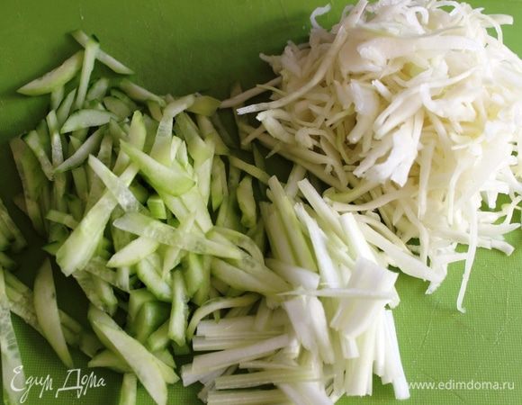 Очистить огурец от кожуры и стебель сельдерея от волокон. Нашинковать капусту, огурец и сельдерей.