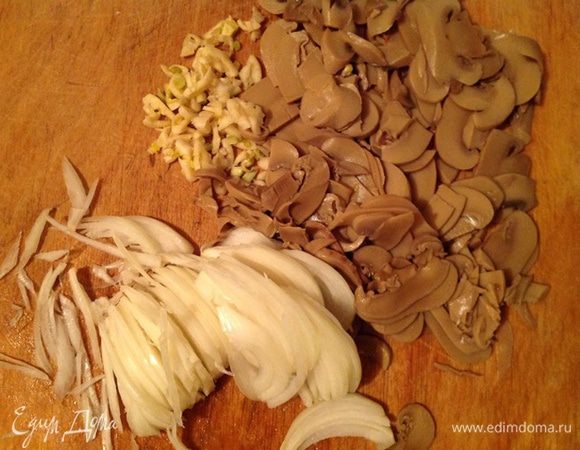 Шампиньоны нарезаем тонкими пластинками, лук- полукольцами, чеснок- на мелкие кусочки.