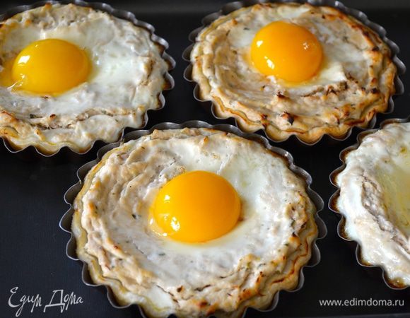 По истечении указанного времени, достать тарталетки из духовки и осторожно выложить в каждую желток. Поставить опять в духовку на 3 минуты. 