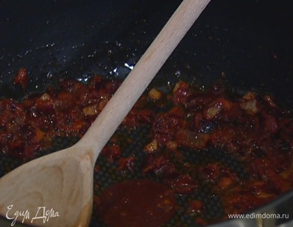 В сковороду с луком добавить измельченные специи, подкопченную паприку, томатную пасту и все перемешать.