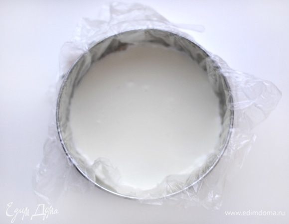 Форму диаметром 18 см застелить пищевой пленкой. Влить на дно формы часть желе, примерно 1-2 см. Поставить в холод, дать застыть.