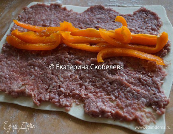 На тесто выложить 1/2 часть фарша и половину перца. Также поступить с оставшимися ингредиентами.