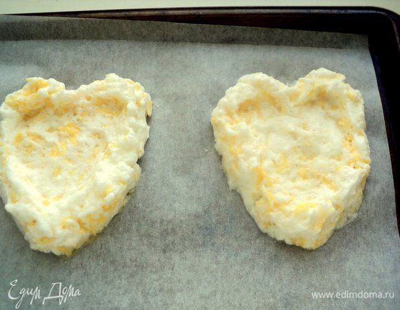 На противень, застеленный бумагой для выпечки (не смазывать), выложить белковую массу в виде сердечек. По серединке сделать углубление.