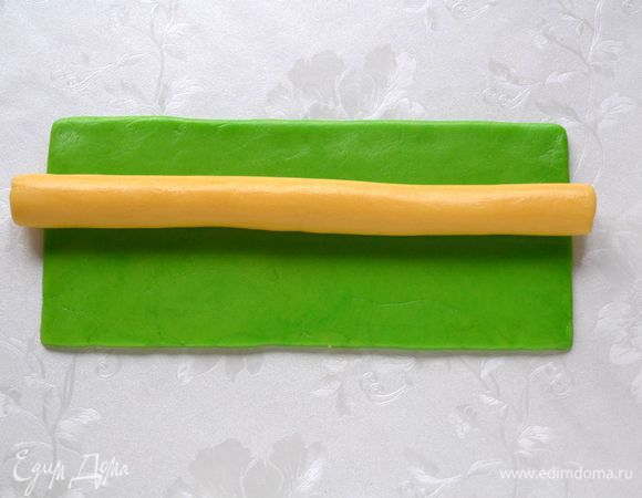 Из светлого теска раскатать колбаску длинной 25 см, выложить на зеленый прямоугольник.