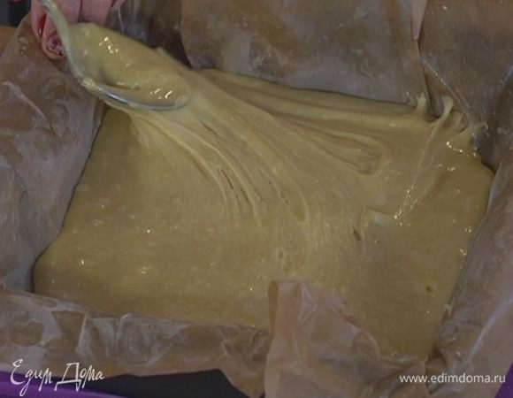 Небольшую форму для выпечки выстелить бумагой и равномерно распределить тесто.