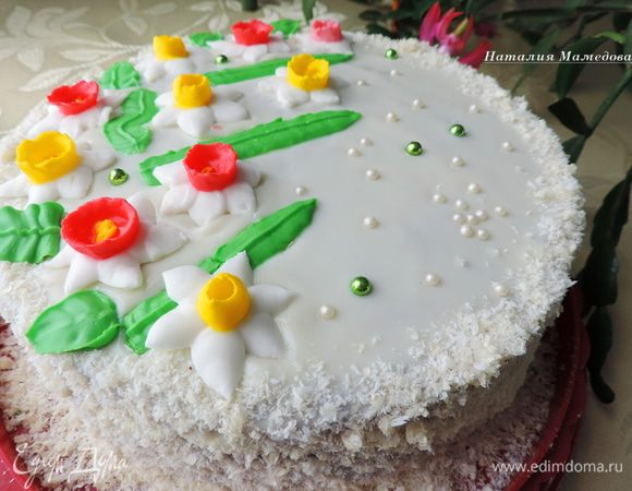 Украшаем торт по своему желанию. Я дала глазури застыть в холодильнике. бока обсыпала смесью кокосовой стружки и вафельной крошки. А на верх торта поместила заранее подготовленные нарциссы из айсинга.