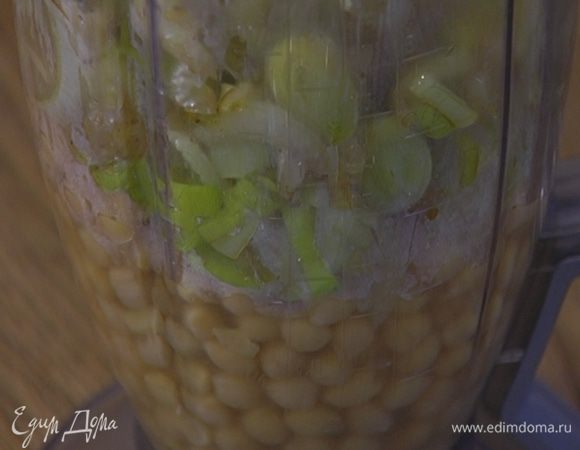 Большую часть отваренного нута поместить в блендер, добавить лук-порей, сельдерей и чеснок и все взбить. Не прекращая взбивать, влить часть жидкости, в которой варился горох, — должно получиться не слишком густое пюре. Посолить и взбить еще немного.