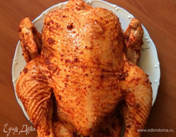 Пока дрова превращаются в угли, подготавливаем фазана - моем, сушим и щедро, не торопясь натираем его аджикой. Перец и соль использовать не стоит, так как аджика острая и достаточно соленая, а излишняя соль не позволит мясу фазана остаться сочным и нежным.