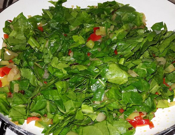 Листья мангольда перебираем, моем, вырезаем плотную часть и режем крупной соломкой. Частями отправляем к луку и перцам, перемешиваем, тушим до мягкости.