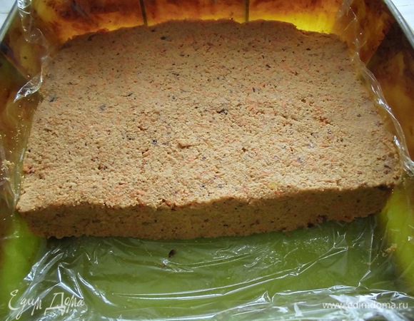 Форму застелить пищевой пленкой и выложить туда подготовленную массу, равномерно распределив ее. У меня не было формы, точно подходящей под размер пирога. Моя была размером 20*20, заполнила я ее где-то на 3/4. Основу убрать в холодильник, пока будет готовиться верхний слой.