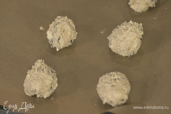 Сформировать из теста небольшие шарики и выложить их на бумагу для выпечки на небольшом расстоянии друг от друга.