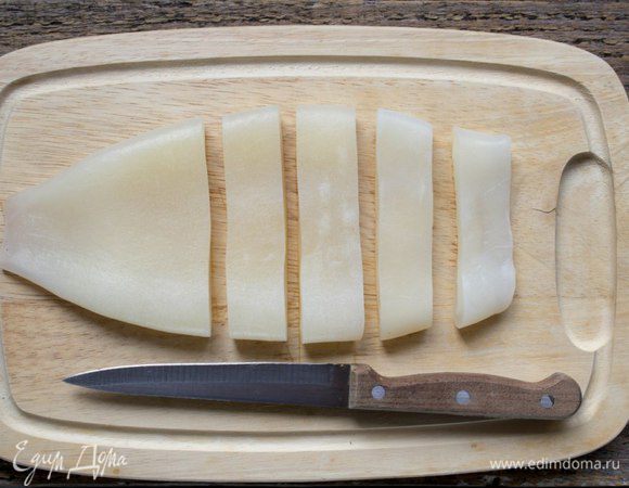 Кальмар обдать кипятком и снять с тушек пленку. Нарезать кольцами.