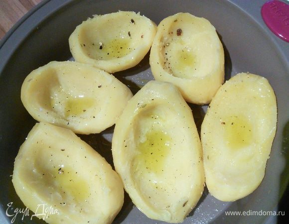 Картошку лучше сварить заранее, непосредственно перед подачей очистить от кожуры, аккуратно выбрать серединку. Выложить в форму, в которой она будет запекаться. Разогреть духовку до 160°С.