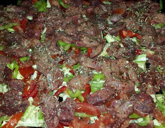 Печень промываем под проточной водой, убираем жир и ненужные жилки и режем небольшими кусочками. Выкладываем печень на овощи, солим, перчим двумя перцами, посыпаем сушеным базиликом, сбрызгиваем оливковым маслом, отправляем в духовку на нижний уровень и включаем её на 200 С.