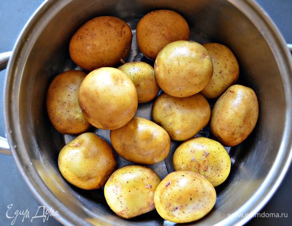 Нам потребуются ровные некрупные клубни картофеля. Его необходимо тщательно помыть и отварить в мундире. Остудить, снять шкурку и порезать кружочками (крупные кружки разрезать пополам).

