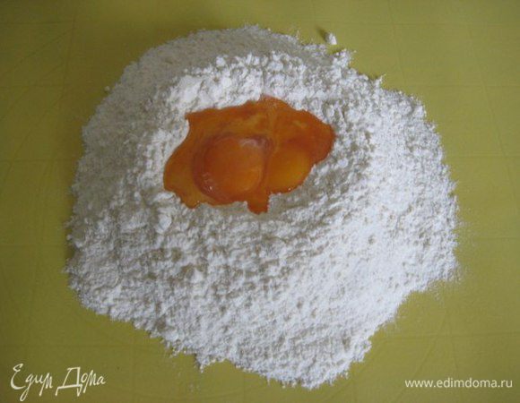 Просеять муку, добавить щепотку соли. Сделать углубление в муке и разбить в него яйца.