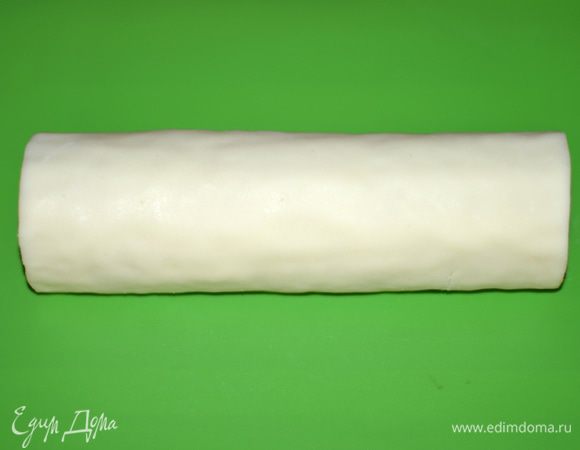 Обтянуть рулет мастикой. Пригладить. Края аккуратно подрезать.