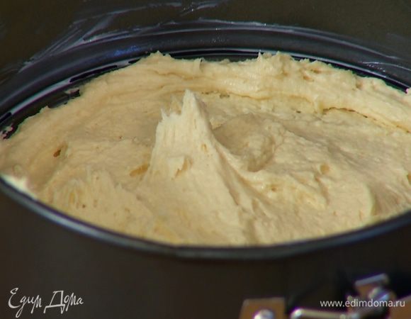 Разъемную форму для выпечки смазать оставшимся сливочным маслом, выложить тесто и равномерно распределить его по дну.