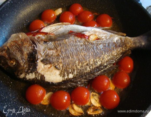 Перевернуть рыбу. Выложить половинки черри. 