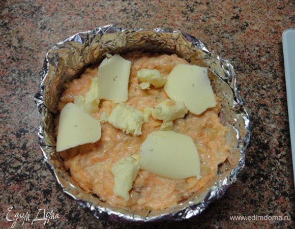 Формочки смазать маслом, посыпать сухарями, выложить морковную массу, а сверху кусочки сливочного масла.