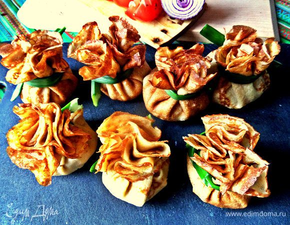 Теперь самое кропотливое: обеими руками собираем края блина к центру, придерживаем, чтобы не распался "мешочек" и завязываем луковой стрелой. Лишнее потом обрезать.