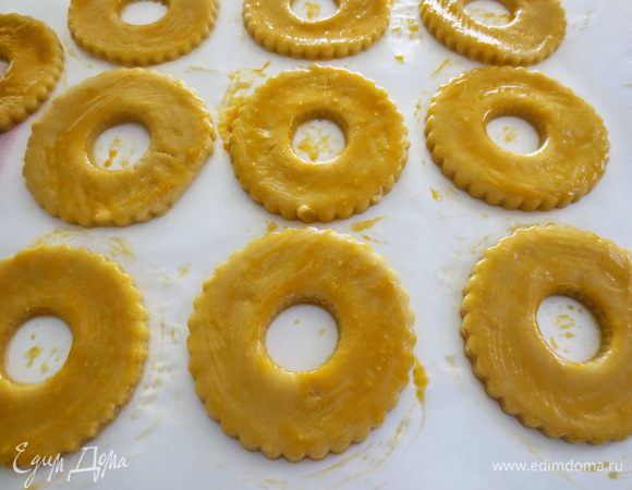 Яичный желток взбить и при помощи кисточки смазать поверхность колец.