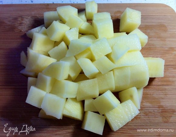 Крупный картофель (или два мелких) вымыть, очистить и нарезать кубиками среднего размера (как и курицу).