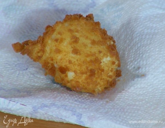 Яйцо в сухарях ложкой опустить в разогретое оливковое масло и обжаривать несколько секунд до появления золотистой корочки, затем выложить на бумажное полотенце, чтобы удалить излишки жира.