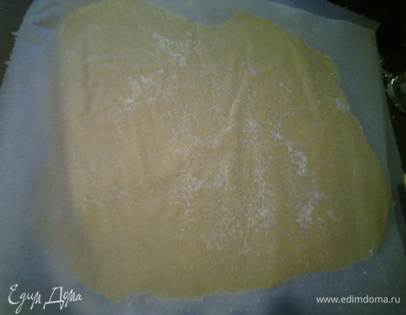 Между двумя пекарскими бумагами раскатать тонко тесто, снять аккуратно верхнюю бумагу. 