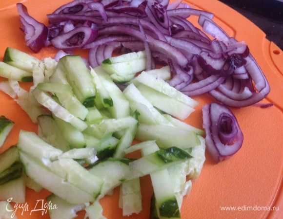 Тонко нарежьте огурцы, лук очистите и нарежьте полукольцами.