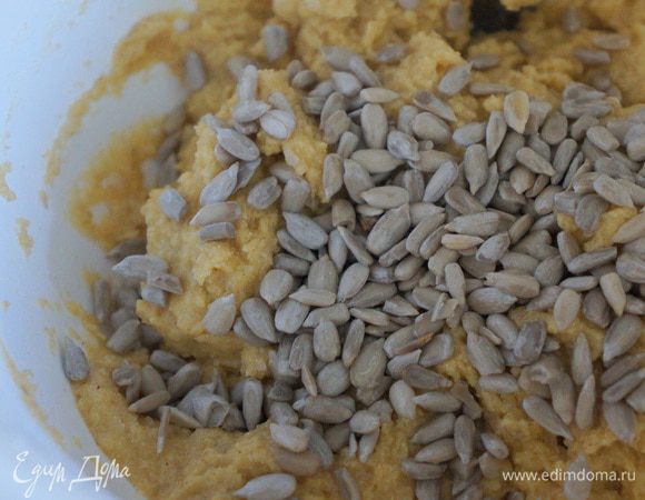 Добавить 12 ст. ложек с горкой кукурузной муки, горсть семечек подсолнечника (или изюма, или орехов). Соду погасить лимонным соком. Всё перемешать. Тесто получается рыхлое. 