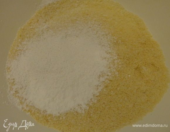 В миске для взбивания хорошенько смешать венчиком миндальную муку, сахарную пудру и одну треть сахара.