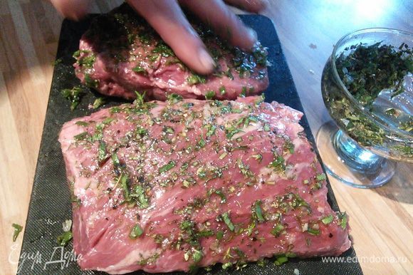 Через час мясо смазать оливковым маслом и втереть в него кашицу из трав и специй. Оставить мясо на час мариноваться.