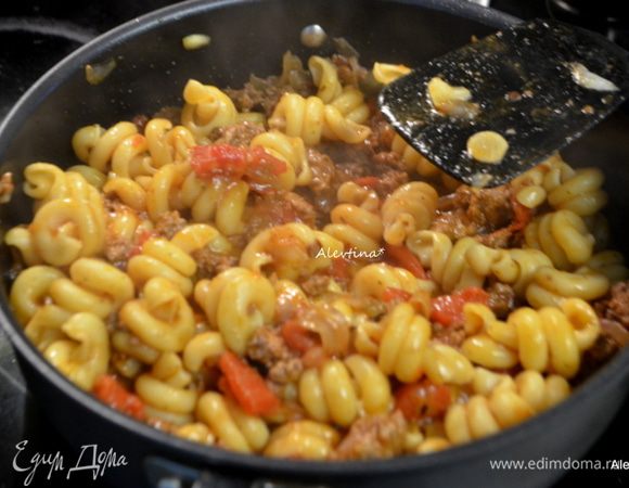 Добавим готовую пасту, перемешаем.  Затем добавим протертый сыр, быстро перемешаем. Снимем с огня и тут же подаем к столу, посыпав зеленью. 