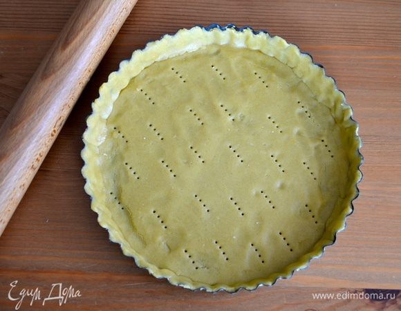 Через указанное время достаньте тесто из холодильника и отрежьте от него 2/3. Раскатайте в пласт и выложите им форму для кростаты (диаметром 24 см), предварительно смазанную сливочным маслом и присыпанную мукой. Наколите тесто по всему периметру вилкой.