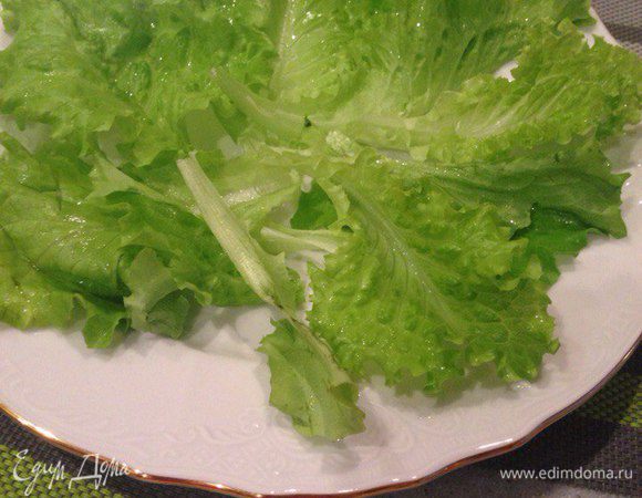 Вымыть листья салата, высушить, выложить на тарелку.