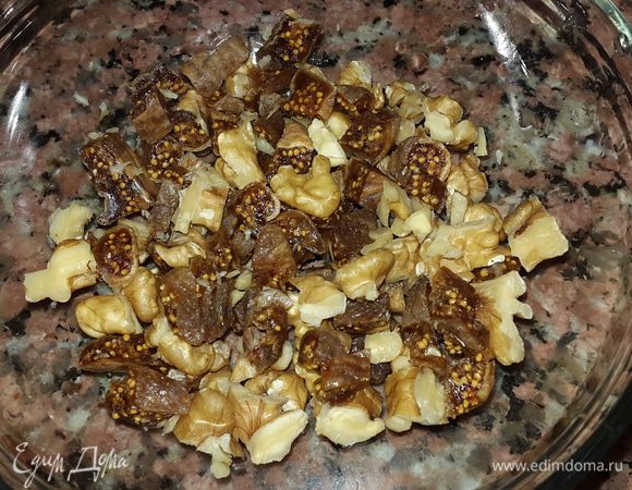 Инжир помыть и нарезать, смешать с порезанными грецкими орехами. Немного орехов также оставить для украшения.