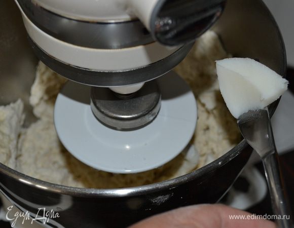 Добавить в миску теплое молоко, воду, оливковое масло и начать замешивать тесто (вручную или с помощью тестомешалки). Добавьте кусочками кулинарный жир. В конце добавьте соль. Замешивать тесто около 10 минут, чтобы активизировать дрожжи. Оно получается эластичным и не липнет к рукам. 