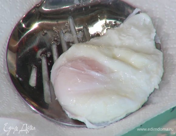 Приготовить яйцо пашот: в небольшой кастрюле вскипятить 500 мл воды, добавить уксус, с помощью венчика сделать маленький водоворот и в центр воронки вылить яйцо. Убавить огонь и варить 2–3 минуты, затем шумовкой выложить яйцо на бумажное полотенце.