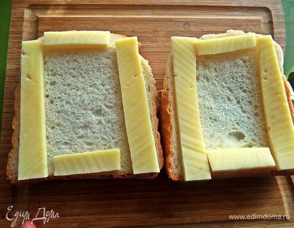 Из брусочка сыра вырезать несколько полосок для скрепления хлеба, остальную часть сыра натереть.