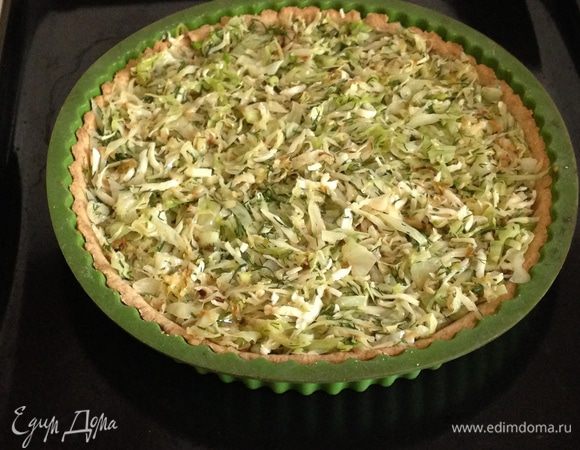 Убрать бумагу вместе с фасолью и выложить на основу капустную начинку, разровнять.
