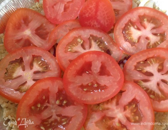 Выложить на основу лук, помидоры.