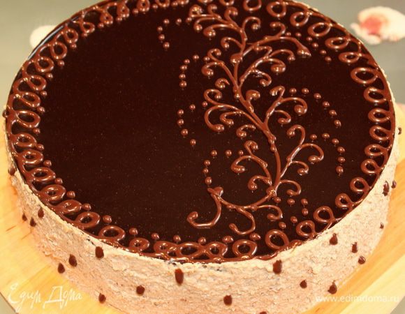 Шоколадный декор. Молочный шоколад растапливаем на водяной бане. Сливки подогреваем до хорошего теплого состояния, но не кипятим, а то они свернуться. Соединяем сливки и растопленный шоколад. Делаем корнет из пергамента и заполняем его шоколадом. Достаем торт из холодильника, обрабатываем бока оставшимся кремом и наносим шоколадный декор. Убираем в холод  на пару часов.