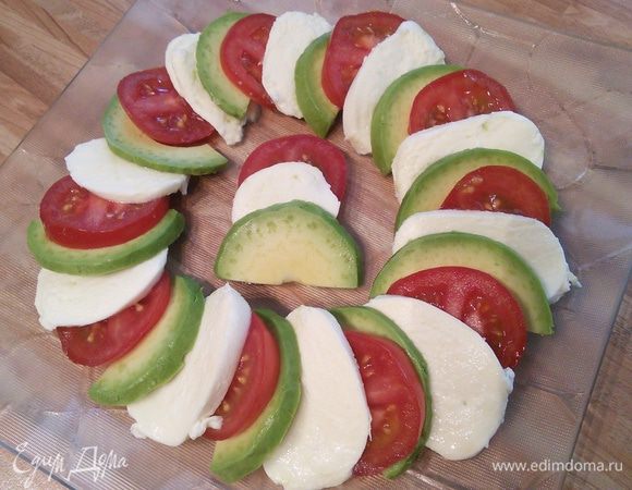 Выложите все продукты на тарелку внахлёст. Посыпьте приправой (у меня "приправа для моцареллы с помидорами". В неё входят высушенные и измельчённые базилик, орегано, чеснок и тимьян. Полейте бальзамическим уксусом и оливковым маслом. 