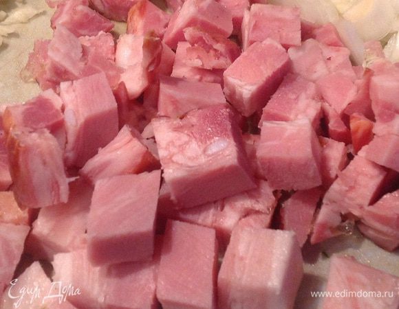 Грудинку тоже нарежьте кубиком, чеснок очистите и выдавите прессом, добавьте в кастрюлю и жарьте еще около 5 минут.